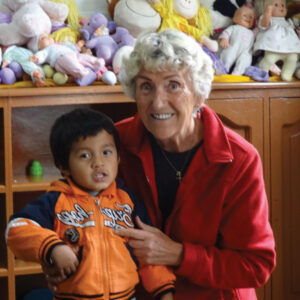 Ingrid McCarroll hugs a young boy