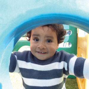 A happy child plays at Santa Lucia