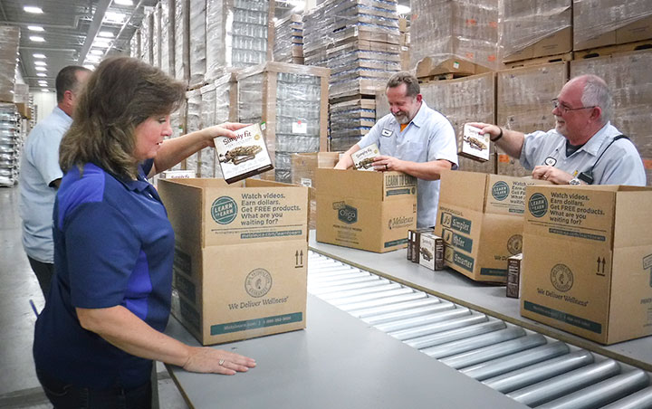 The Knoxville, KY warehouse team packs boxes for relief efforts